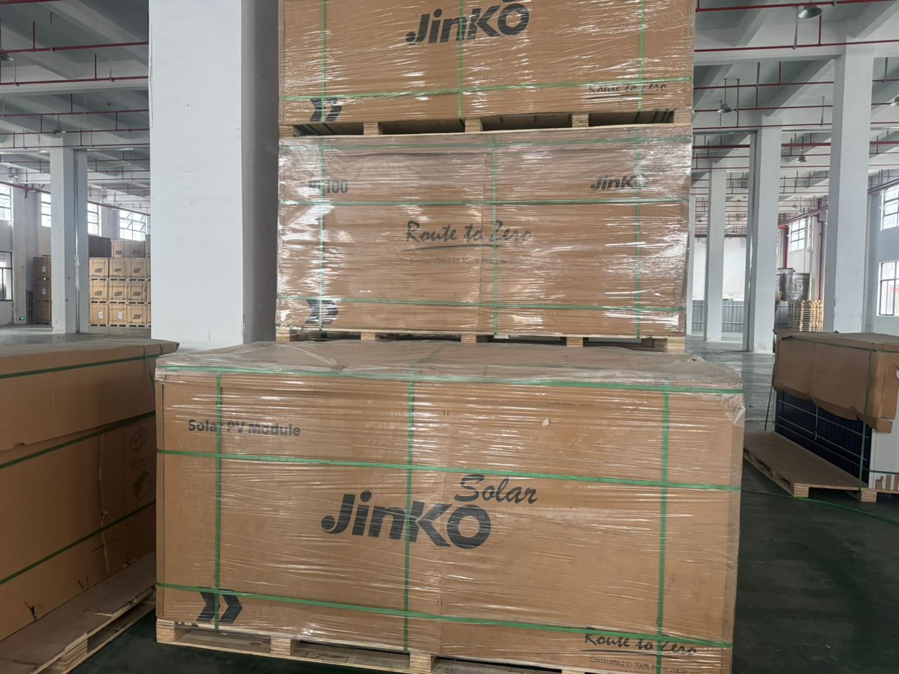 Crated solar PV modules stacked on pallets ready for supply